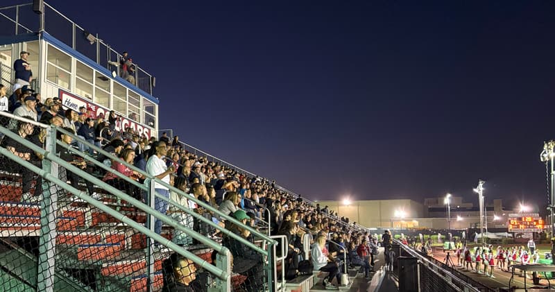 Football Game Crowd Enjoys Evening Under Stadium Lights