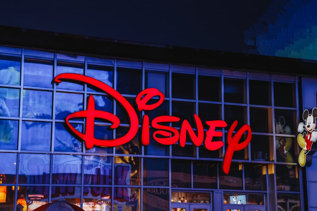 The iconic disney logo illuminated at night.