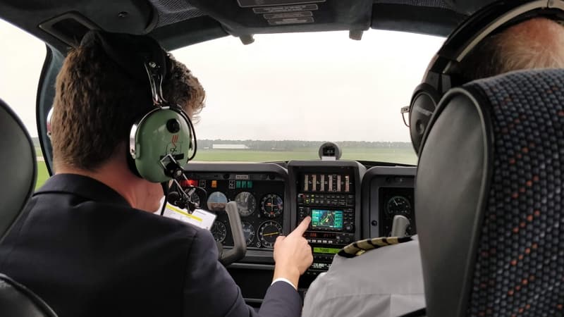 Student pilot checking the navigation equipment of a TB-10 aircraft