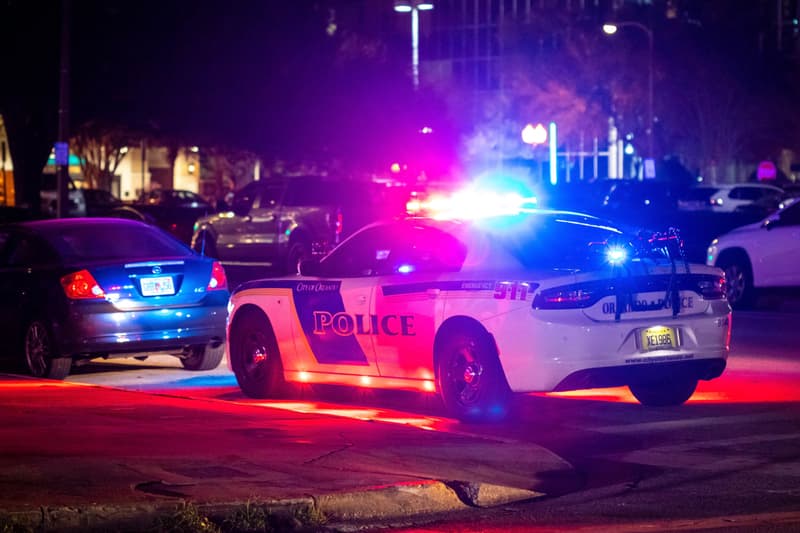 Police car with emergency lights flashing at night in city