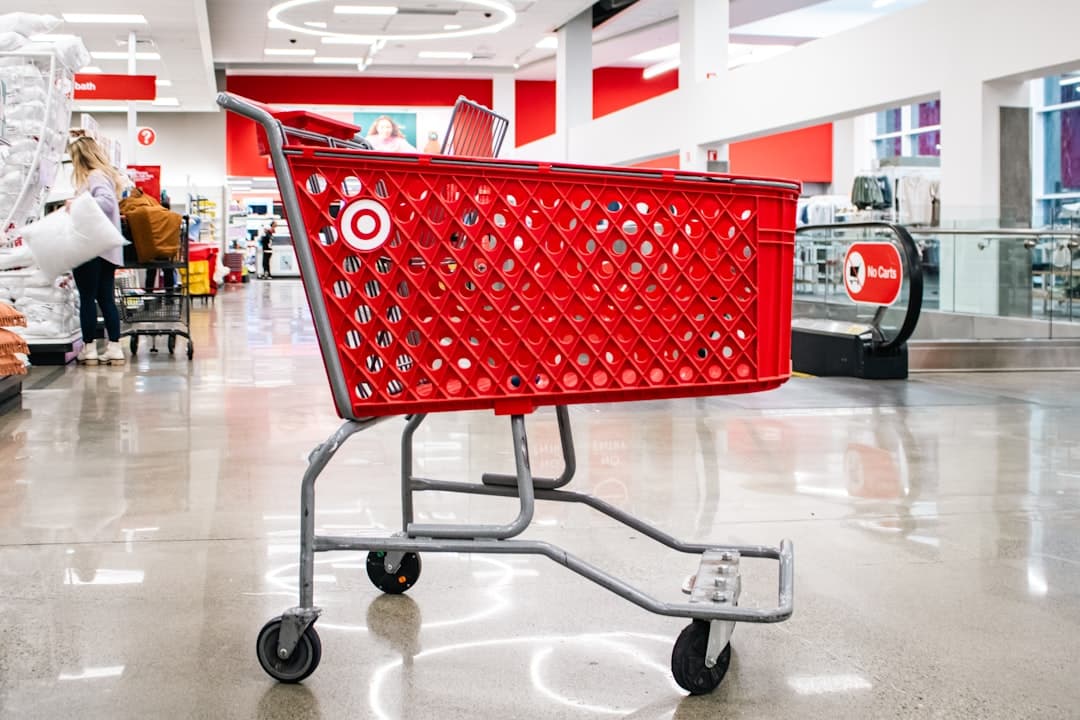 An empty red Target shopping cart within a Target store.