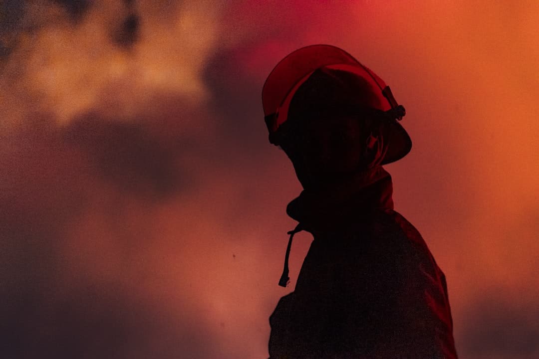 firefighter silhouette with smoke and light